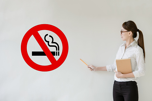 No smoking tobacco addict business woman, student or teacher on blackboard background