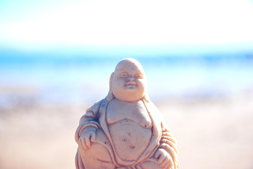 Buddha Idol Stage on the Beach Image for Mindfulness. This image is filtered with for a modern-look.