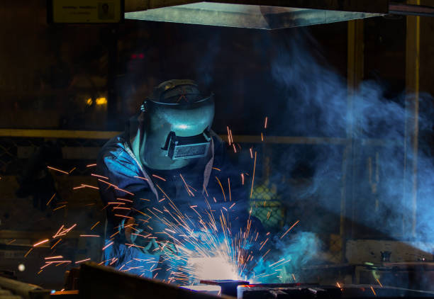 istock Close-up worker is welding with protective mask in factory 689190334