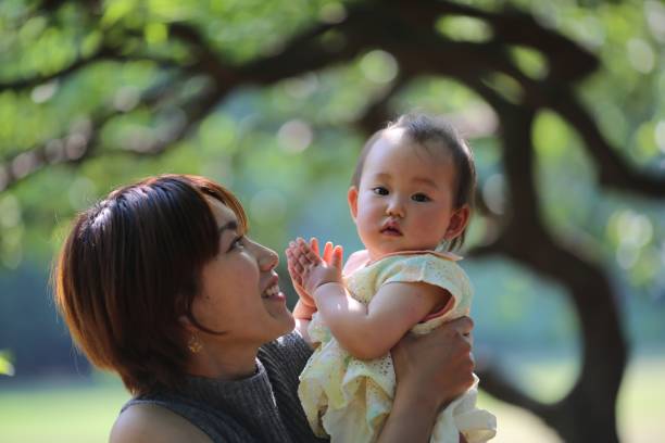 istock Mother holding her baby at spring park 689190922