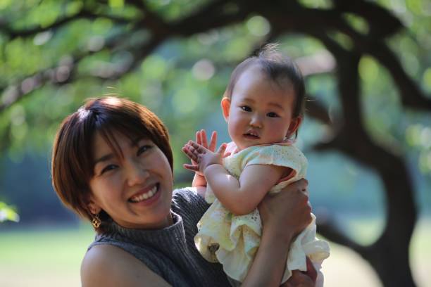 istock Mother holding her baby at spring park 689191392