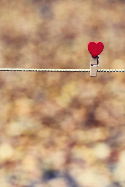 istock heart holding on rope with blur bokeh background 689193620