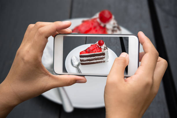 istock Taking photo of cake on wooden table. 689193744
