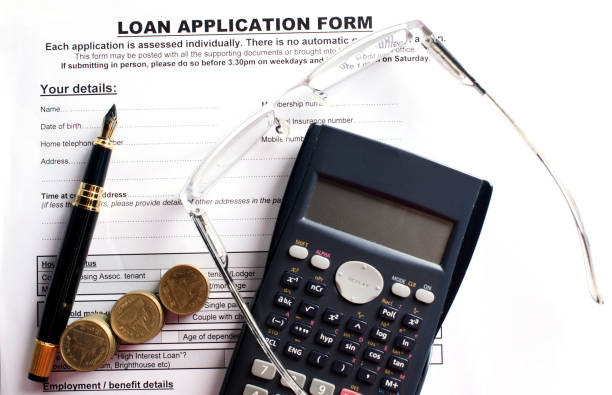 istock Business fountain pen and eyeglasses with calculator and coins stack on loan application document for finance ideas concept backgrounds above 689202598