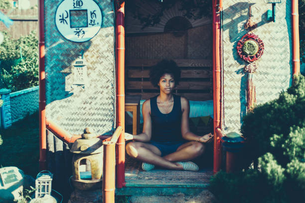istock Mixed young curly girl practicing yoga in pagoda 689205452