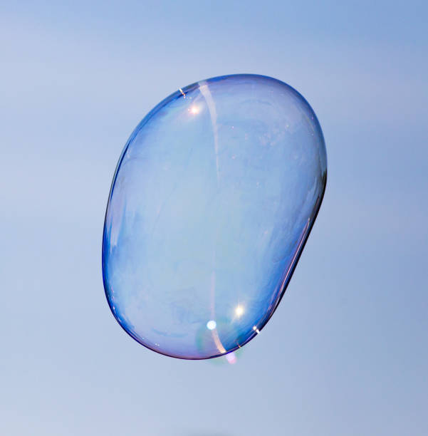istock Big soap bubble against the blue sky 689208740