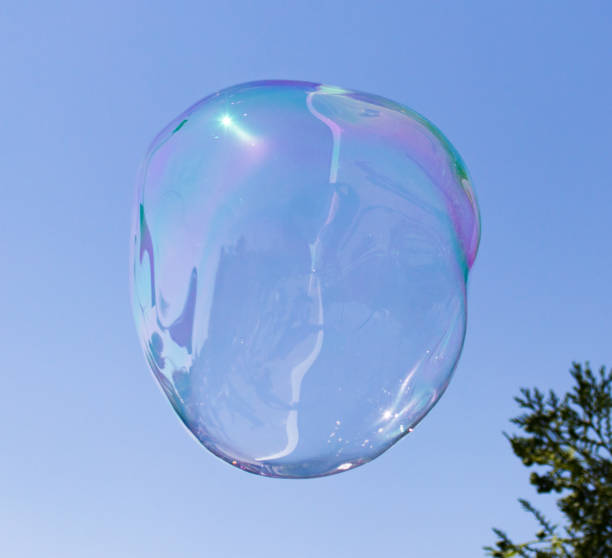 istock Big soap bubble against the blue sky 689210110