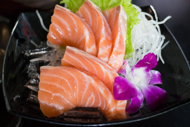 istock Sliced Salmon Sashimi Served On Black Plate 689213432