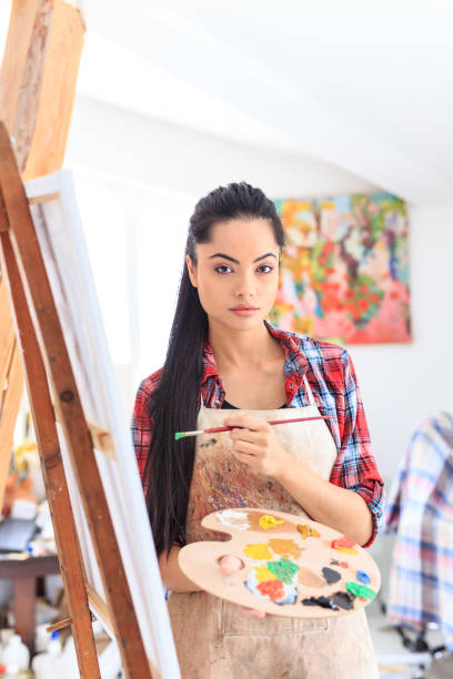 istock Young woman drawing in art studio 689215986