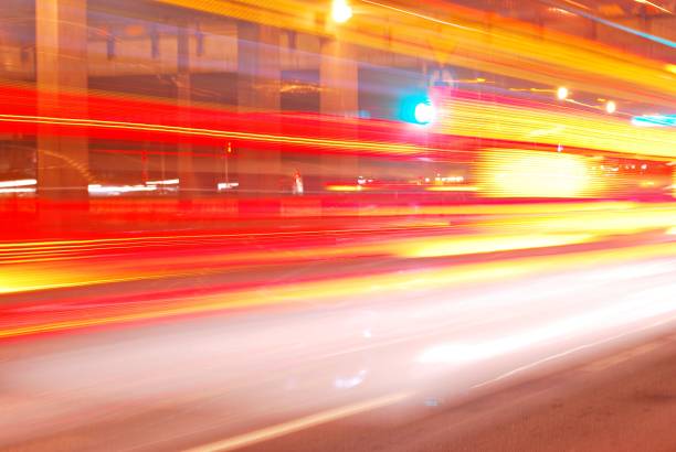 istock Fast moving car light in city at night 689234540