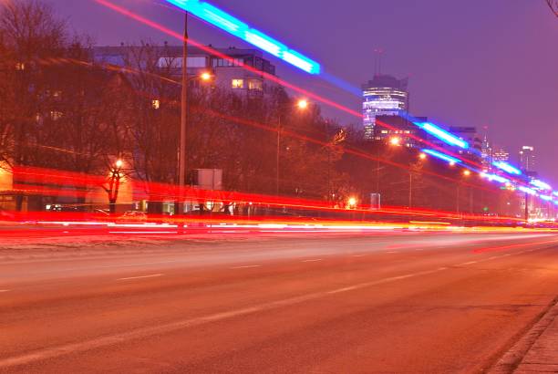 istock Fast moving car light in city at night 689234814