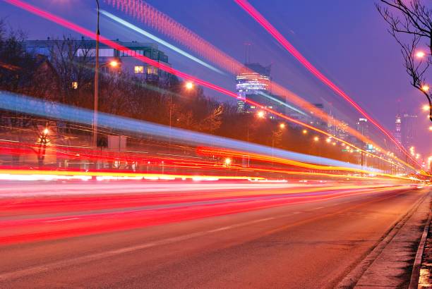 istock Fast moving car light in city at night 689234962