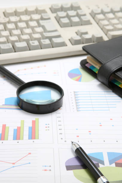 istock Business concept.  Business documents, pen, magnifying glass, and notebook with computer keyboard. 689237594