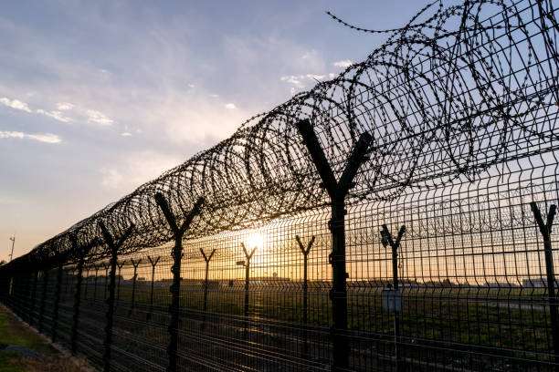 istock barbed wire around airport 689237962