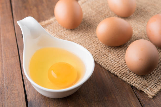 istock Raw eggs on sackcloth on wooden table 689242348