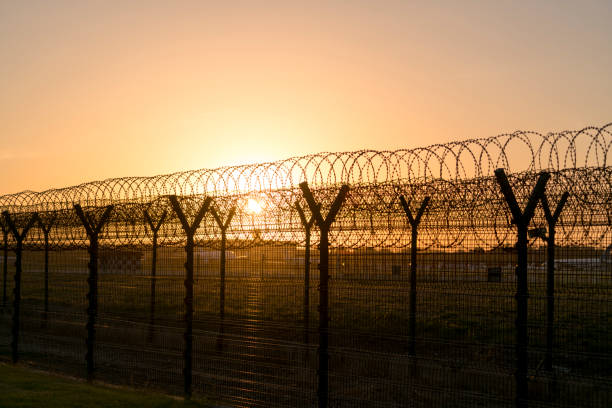 istock barbed wire around airport 689243518