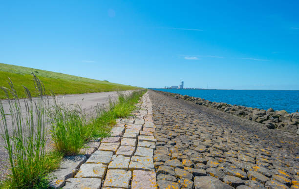 istock Dike of basalt stones along a lake in spring 689246374