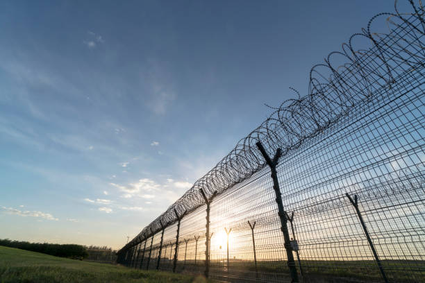 istock barbed wire around airport 689249056