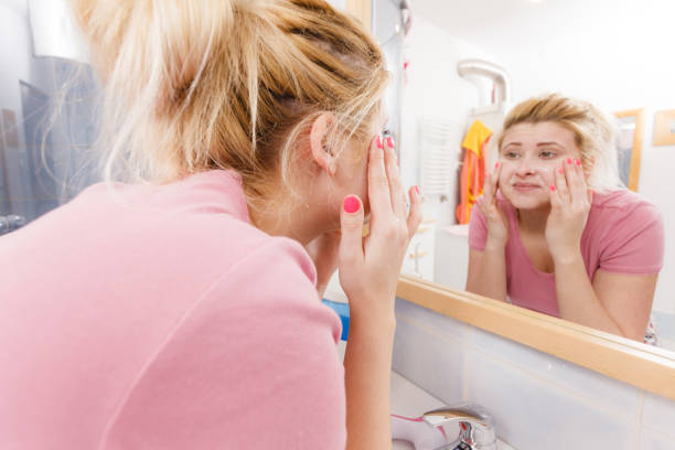 istock Happy woman washing her face under sink 689249398