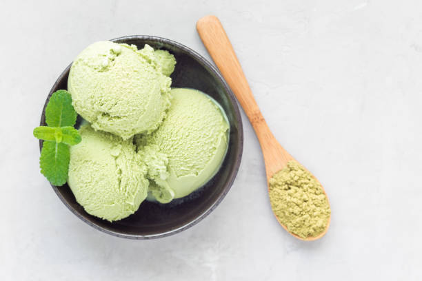 istock Matcha green tea ice cream balls in black bowl, horizontal, top view, copy space 689252064