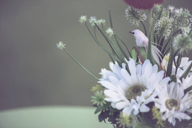 Beautiful flowers in the garden with decorative swan made of rubber.