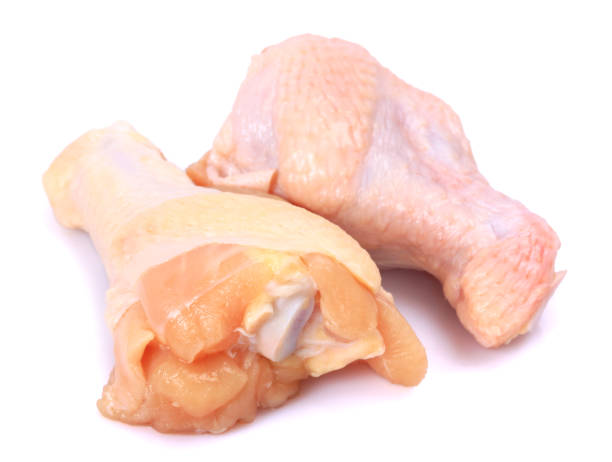 istock Raw chicken drumsticks with skin on white background 689260412