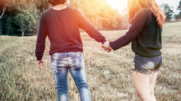 istock Lovers walk hand in hand on romantic evening sun, romantic atmosphere. 689264506