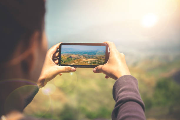 istock Woman hand using mobile phone photo. Mountain nature 689266716