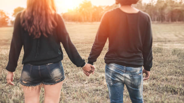istock Lovers walk hand in hand on romantic evening sun, romantic atmosphere. 689267526