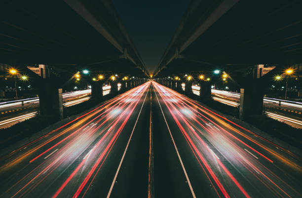 istock Fast moving traffic with red light trails on black asphalt motorway 689270686