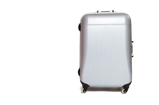 Front view of the silver shell suitcase standing on the white background.