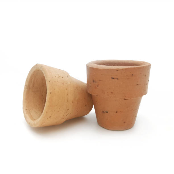 istock Little clay pots on white background 689277588