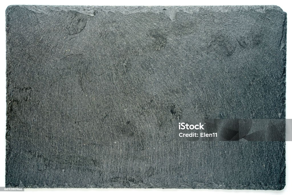 Rectangular black textured slate board for dishes isolated on white background Stone Material Stock Photo
