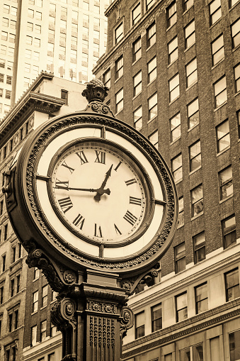 Manhattan Sidewalk Clock at 5th Avenue in New York City (USA). Edited as a vintage photo with dark edges.