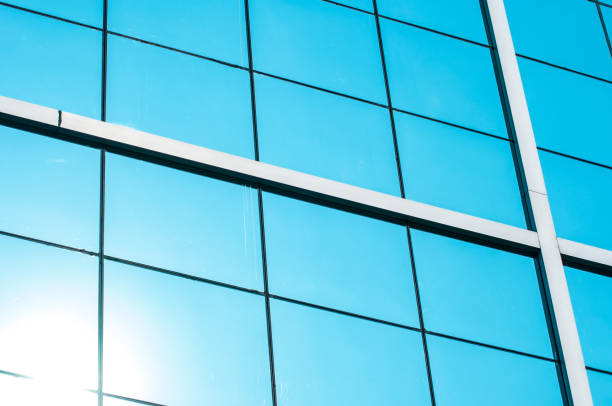 istock Mirror windows of building reflect blue sky and sun 689284244