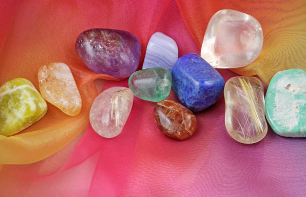 istock Chakra healing gemstones on Rainbow Chiffon Material Background 689284858