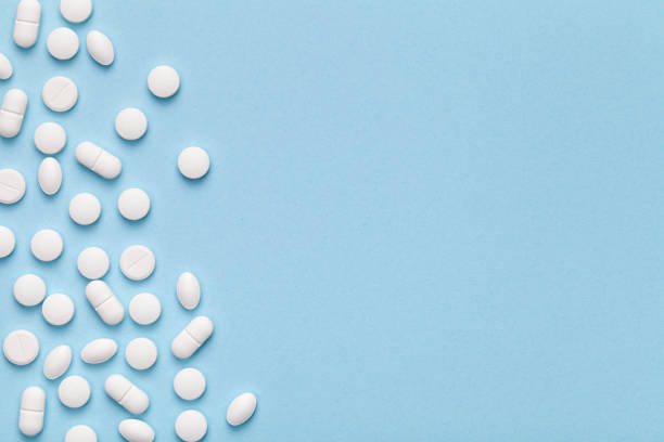 istock Medical Pills on Blue Background 689284988