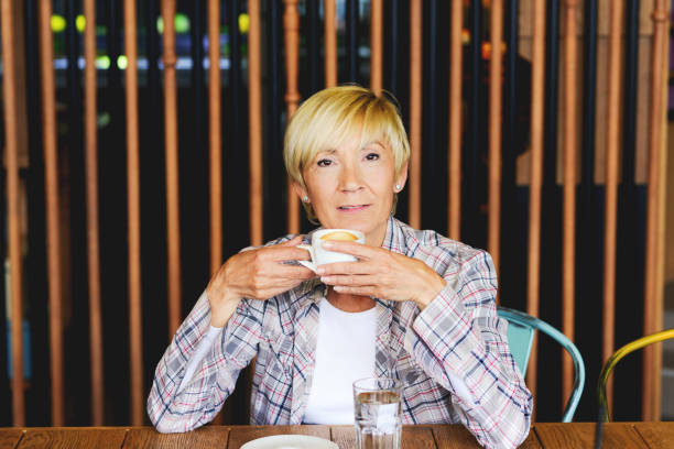 istock Blond woman in restaurant - having coffee 689287766