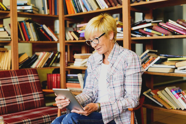 istock Beautiful woman with glasses reading a text 689288786