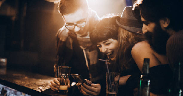 laughing at the photo - after work beautiful people beer beer bottle imagens e fotografias de stock