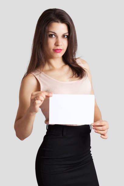 istock Young beautiful business woman holds a sheet 689294500
