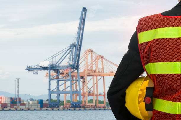 istock Hand or arm of engineer hold yellow plastic helmet 689295300