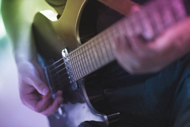 istock Close up of a man playing electric guitar 689298238