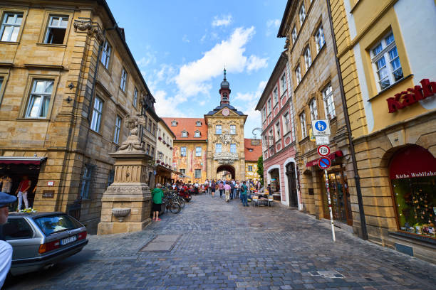 Photo of the Old Town Hall (Altes Rathaus) in Bamberg, Germany. Tourists walking through the gate.