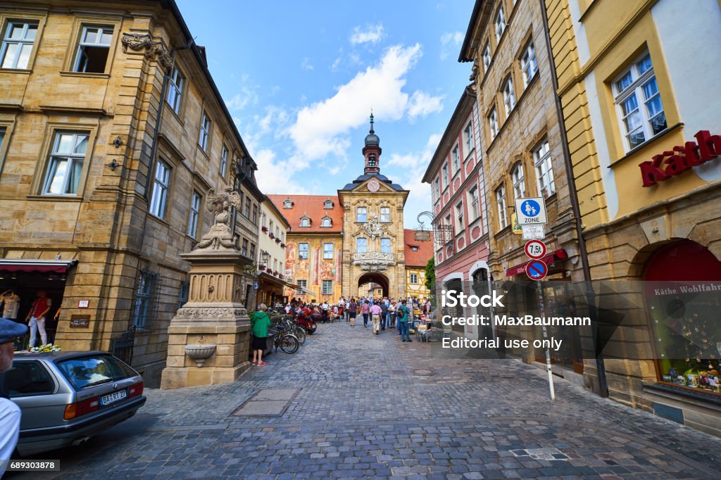 Tourists at Bamberg Old Town Hall Photo of the Old Town Hall (Altes Rathaus) in Bamberg, Germany. Tourists walking through the gate. Bamberg Stock Photo