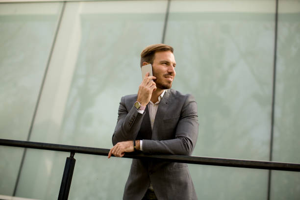 istock Handsome young businessman with mobile phone 689304144
