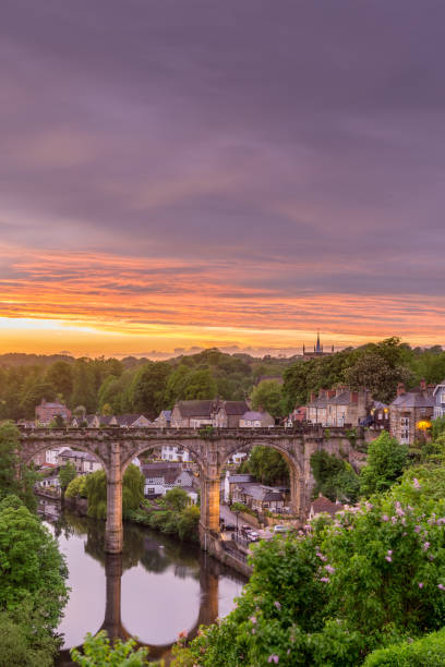 The classic view of the river Nidd and railway viaduct at sunset on a summer evening in the town of Knaresborough North Yorkshire England