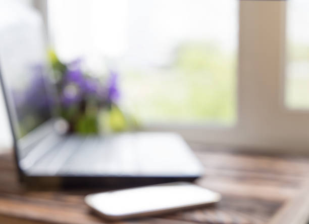 istock Background defocused office work place with table, laptop and phone 689316634