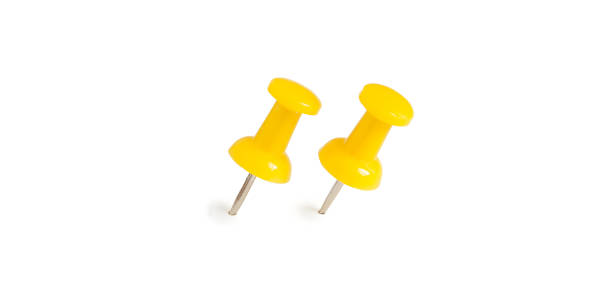 istock two isolated yellow push pins in white background 689317958