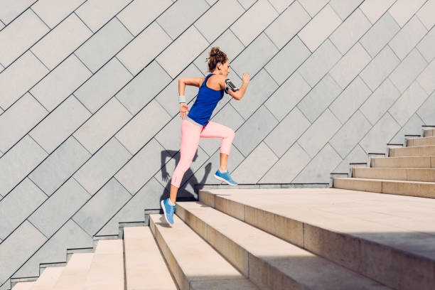 istock Sportswoman running upstairs 689320398